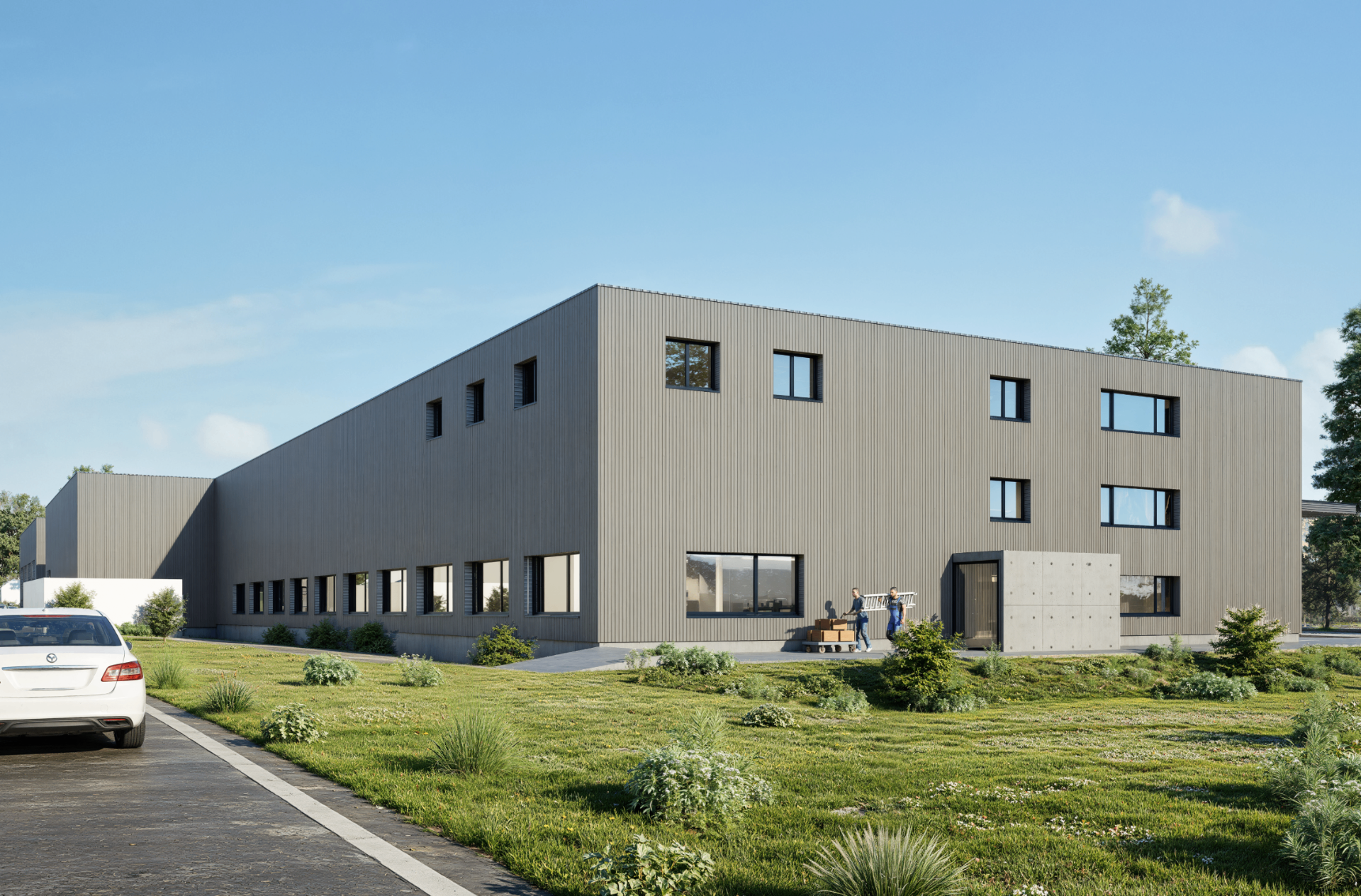Industriegebäude, Rückansicht mit Nebenerschliessung und Grünfläche